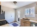Bright kitchen features stainless steel appliances, wood countertops and cabinets, and stylish tile backsplash at 3061 W 18Th Ave, Denver, CO 80204