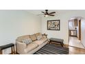 Cozy living room with a striped rug, comfortable seating and an inviting archway to the kitchen at 3061 W 18Th Ave, Denver, CO 80204