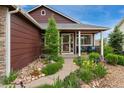 Inviting front porch with colorful landscaping leading to the home's entrance at 12888 Buckhorn Creek St, Parker, CO 80134