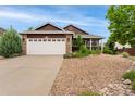 Beautiful home featuring stone accents, a two-car garage, and a professionally landscaped front yard at 12888 Buckhorn Creek St, Parker, CO 80134