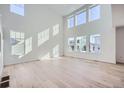 Spacious living room with hardwood floors and large windows at 4620 Thistle Dr, Brighton, CO 80601