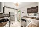 Well-lit kitchen with stainless steel appliances, stylish counters and door to backyard at 1800 Grove St, Denver, CO 80204