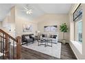 Bright living room with vaulted ceilings, elegant decor, and beautiful flooring at 3968 Ashcroft Ave, Castle Rock, CO 80104