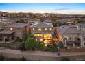 Backyard view featuring a multi-tiered deck, lawn, and neighborhood landscape in a comfortable suburban setting at 10601 Montecito Dr, Lone Tree, CO 80124