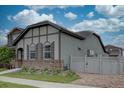 Side view of a home with stone accents, a fenced yard, and low-maintenance landscaping in a suburban setting at 6612 N Ceylon St, Denver, CO 80249