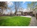 Spacious backyard with a concrete patio and a large grassy area perfect for outdoor activities at 1492 S Dudley St, Lakewood, CO 80232