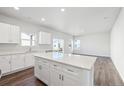 Spacious and well-lit kitchen with an island, sleek countertops and ample cabinet space at 2145 Flower Blossom Ave, Brighton, CO 80601