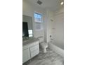 Bathroom with a shower/tub combo, toilet and white vanity at 5124 N Quemoy St, Aurora, CO 80019