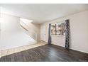 Bright living room featuring hardwood floors and a staircase to the upper level at 12662 W Virginia Ave, Lakewood, CO 80228