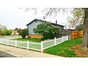 Backyard view showing fenced yard and large trees at 1528 Coronado Pkwy, Denver, CO 80229