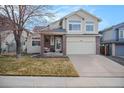 Inviting two-story home boasts a manicured lawn, two-car garage, and appealing curb appeal at 11613 W Coal Mine Dr, Littleton, CO 80127