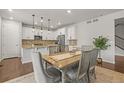 Open floor plan showcasing the kitchen, dining area, and modern finishes at 14881 Chicago St, Parker, CO 80134
