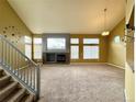 Bright living room with a fireplace, vaulted ceilings, lots of natural light, and carpeted floors for a cozy feel at 20532 E Lake Cir, Centennial, CO 80016