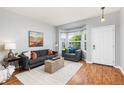 Cozy living room featuring hardwood floors, a bay window, and comfortable seating at 5733 S Yakima Way, Aurora, CO 80015