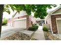 Charming home exterior featuring a brick facade, attached garage, and inviting courtyard at 9873 Greensview Cir, Lone Tree, CO 80124