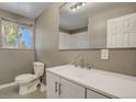 Bathroom with a white vanity, toilet, and neutral wall color at 3055 Carson St, Aurora, CO 80011