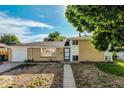 Charming brick home with an attached garage and low-maintenance front yard landscaping at 3055 Carson St, Aurora, CO 80011