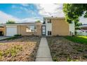 Charming brick home with an attached garage and low-maintenance front yard landscaping at 3055 Carson St, Aurora, CO 80011