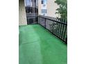Spacious outdoor balcony with artificial turf and black metal railings, providing a private and refreshing open-air living experience at 13601 E Marina Dr # 508, Aurora, CO 80014