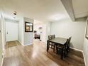 Open-concept dining room featuring a dark wood dining table and chairs adjacent to the kitchen at 8625 Clay St # 228, Westminster, CO 80031