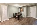 Dining room includes a table with seating for four, light hardwood flooring, and gray walls at 8625 Clay St # 228, Westminster, CO 80031