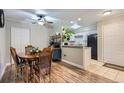 Charming dining area next to the kitchen features a wooden table with seating for four at 2280 S Oswego Way # 104, Aurora, CO 80014