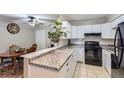 Well-lit kitchen featuring white cabinets and modern appliances, perfect for cooking at 2280 S Oswego Way # 104, Aurora, CO 80014