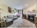 Inviting living room boasts a modern fireplace, and light-filled ambiance with views of the outdoors at 2280 S Oswego Way # 104, Aurora, CO 80014