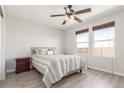 Bright bedroom features a ceiling fan, neutral walls and a comfortable queen-sized bed at 5530 Lewiston Ct, Denver, CO 80239