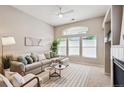 Inviting living room featuring a comfortable sofa, ceiling fan, and plenty of natural light at 2870 W Riverwalk Cir # B, Littleton, CO 80123