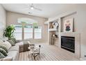 Bright living room featuring a fireplace, large windows and a comfortable sofa at 2870 W Riverwalk Cir # B, Littleton, CO 80123
