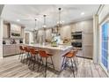 Gorgeous kitchen with stainless appliances, marble countertops, and island seating at 6973 Daventry Pl, Castle Pines, CO 80108