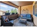 Cozy covered patio featuring a wicker sofa and chair set for relaxing outdoors at 9836 W Freiburg Dr # 4E, Littleton, CO 80127