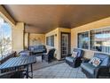Spacious covered patio with seating, perfect for enjoying the outdoors in comfort at 9836 W Freiburg Dr # 4E, Littleton, CO 80127