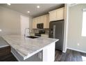 Modern kitchen featuring stainless steel appliances, granite countertops, and ample cabinet space for storage and meal preparation at 3427 Cade Ct, Castle Rock, CO 80104