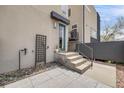 Contemporary home's entry with a well-designed patio, steps to the front door, and tasteful landscaping at 2607 W 24Th Ave, Denver, CO 80211