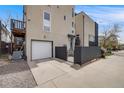 Modern home exterior with a secure drive, a garage and a small terrace on the upper level at 2607 W 24Th Ave, Denver, CO 80211