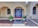 Inviting entryway showcasing double doors with decorative glass, flanked by potted plants at 7504 E Jefferson Dr, Denver, CO 80237