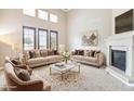 Bright living room featuring neutral decor, fireplace, and comfortable seating arrangement at 4775 S Anaheim Ct, Aurora, CO 80015