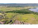 Scenic aerial view showcasing the community's proximity to green space, lakes, and city at 4603 S Abilene Cir, Aurora, CO 80015