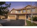 Attractive townhome featuring a two-car garage, tile roof and inviting front entrance at 4603 S Abilene Cir, Aurora, CO 80015