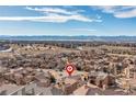 Expansive aerial view of a residential neighborhood with mountain views in the distance at 9228 Sori Ln, Highlands Ranch, CO 80126