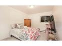 Cozy bedroom with a patterned bedspread, wood armoire, and ample natural light from the window at 5995 W Hampden Ave # 3H, Denver, CO 80227