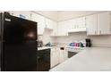 Functional kitchen featuring laminate countertops, white cabinetry, and black appliances at 5995 W Hampden Ave # 3H, Denver, CO 80227