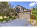 Charming home with a two-car garage, complemented by rock landscaping and a well-maintained lawn at 16247 E Belleview Pl, Centennial, CO 80015