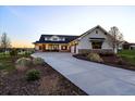 Charming stucco home featuring a wide driveway, stone accents, and well-maintained landscaping at 2741 Morning Run Ct, Franktown, CO 80116