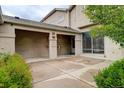 Spacious back patio featuring a covered area with a light fixture, leading to a sliding glass door and greenery at 490 Jackson St, Denver, CO 80206