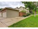 Charming home featuring a two-car garage, private fenced yard, and beautifully landscaped front lawn at 490 Jackson St, Denver, CO 80206