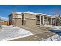 Two-story home with attached two-car garage and covered porch, snow on the ground at 7071 Greenwater Cir, Castle Rock, CO 80108