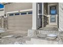 Two-car garage with attached entryway and stone accents at 7071 Greenwater Cir, Castle Rock, CO 80108